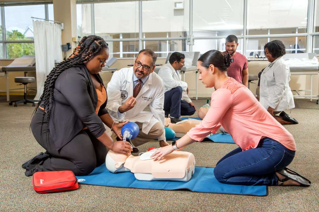 SMU Dean, Dr. Basu, provides passionate feedback to students during CPR lesson