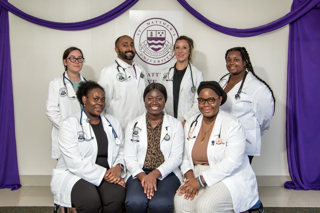 St. Matthew's University School of Medicine students pose for picture in their white coats