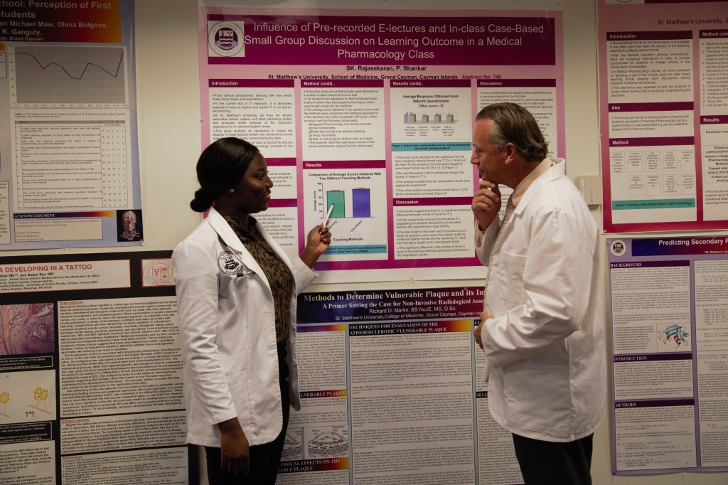 SMU Medical student shares her research project with faculty member