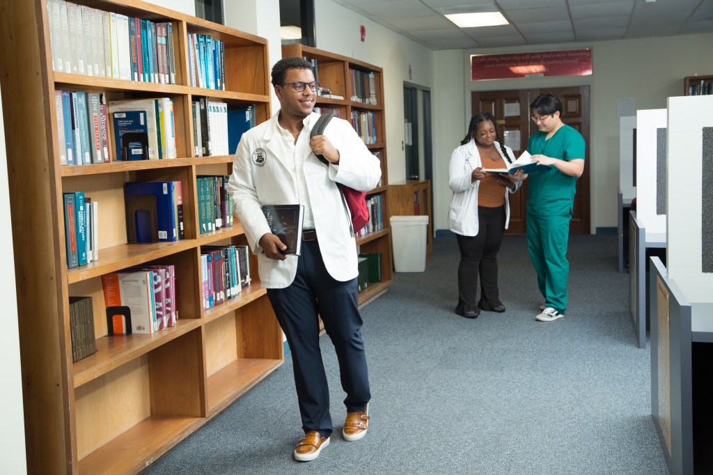 St. Matthew's University School of Medicine students working in library