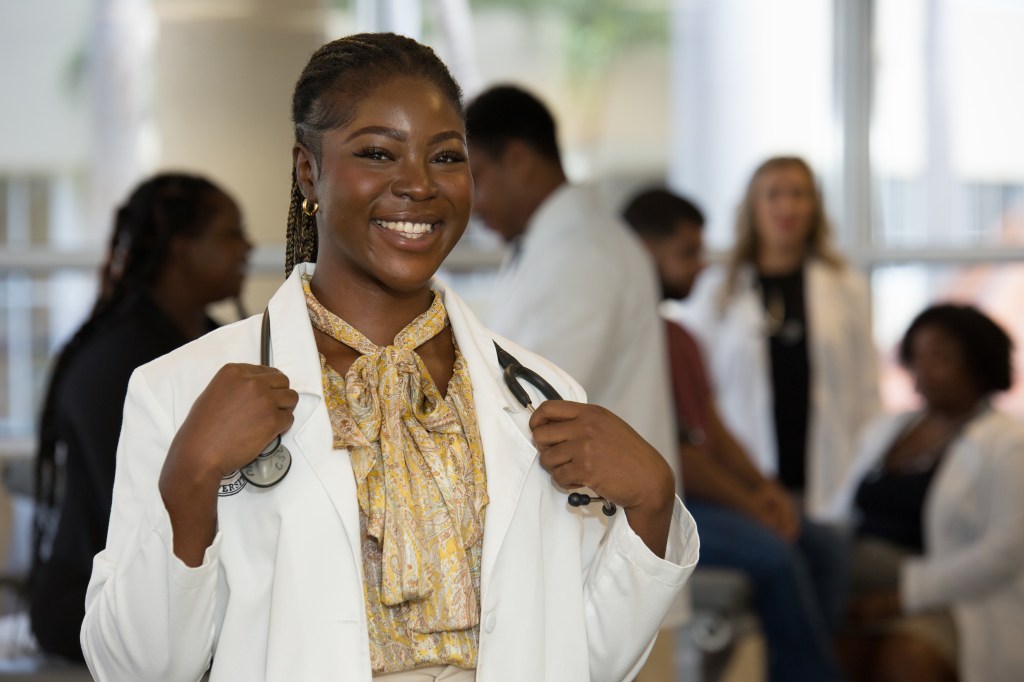 Current SMU Medical Student wearing white coat
