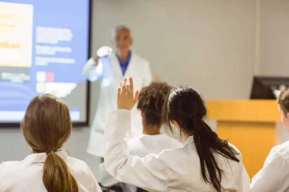 medical student raising hand in class